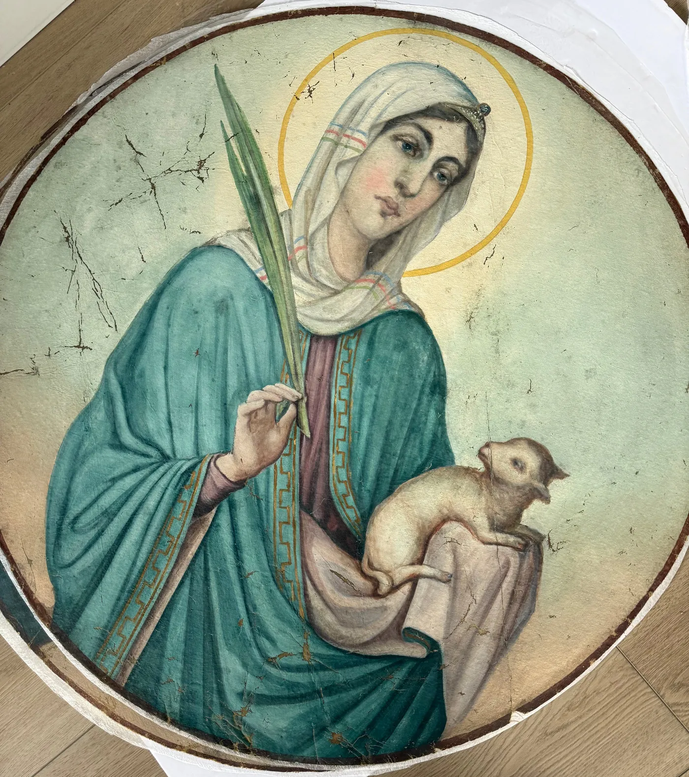 Conserved circular devotional painting of a saint holding a lamb